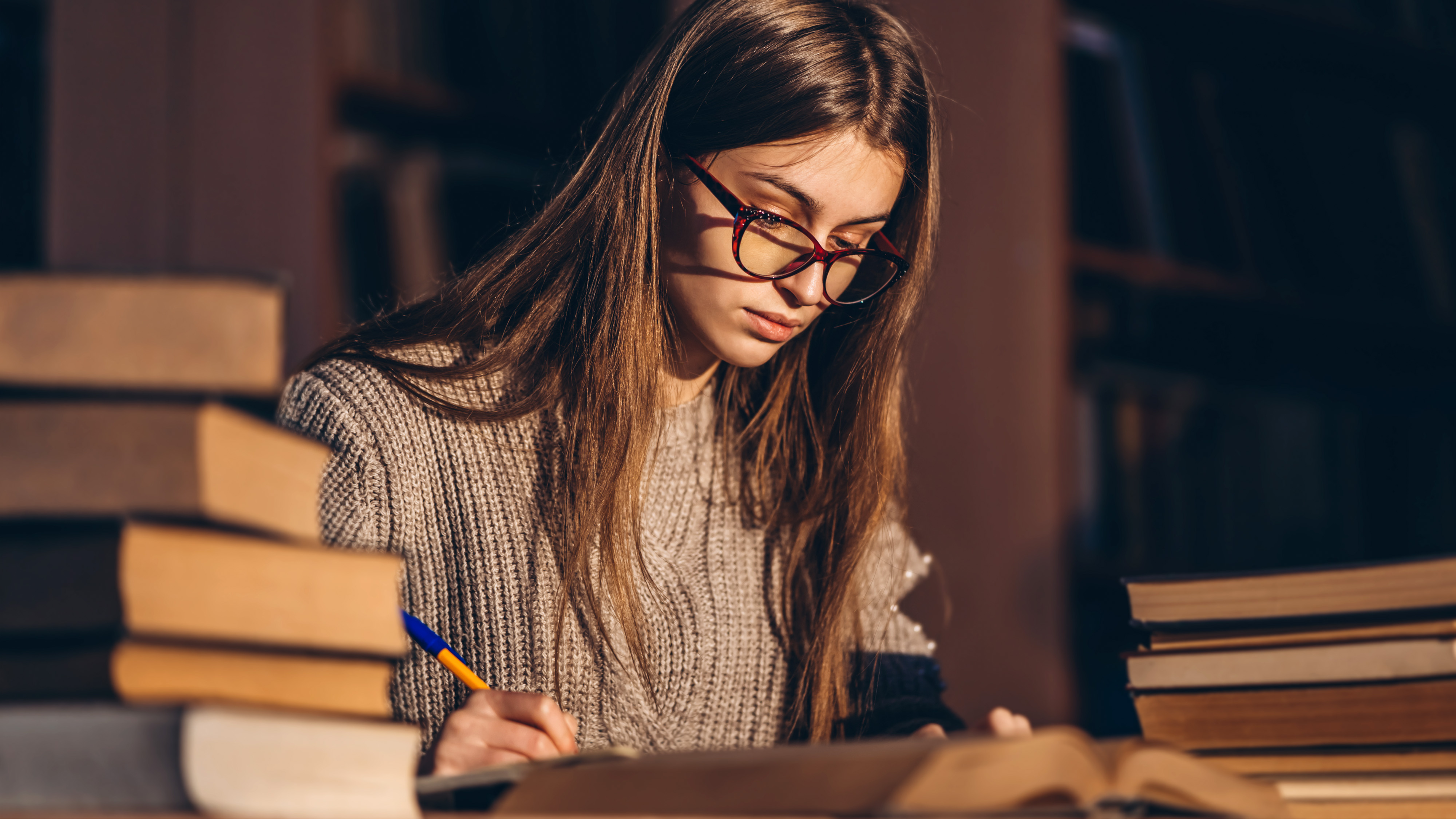 Doctoral researcher working in the library on their research plan